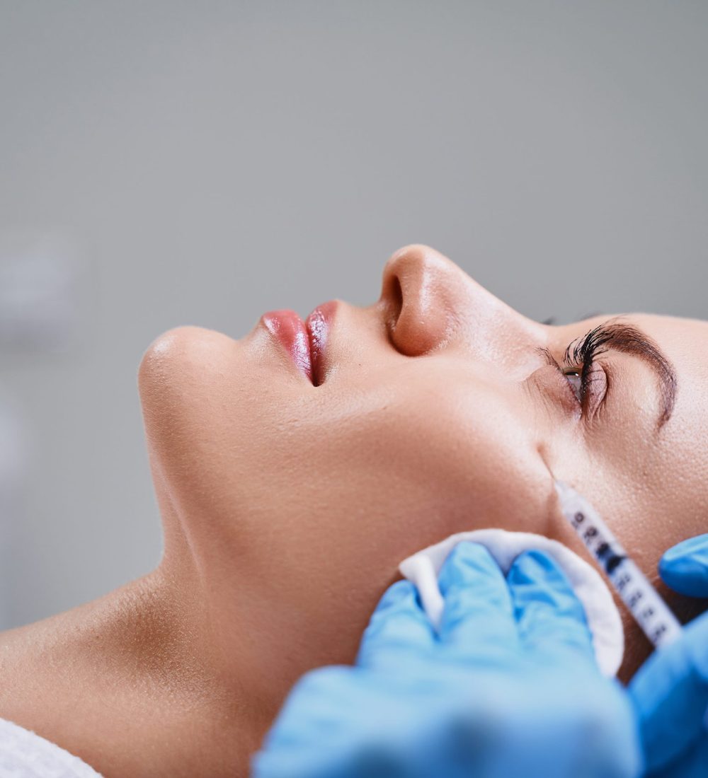 Young girl is visiting cosmetologist and getting beauty injections for rejuvenation face and lifting skin