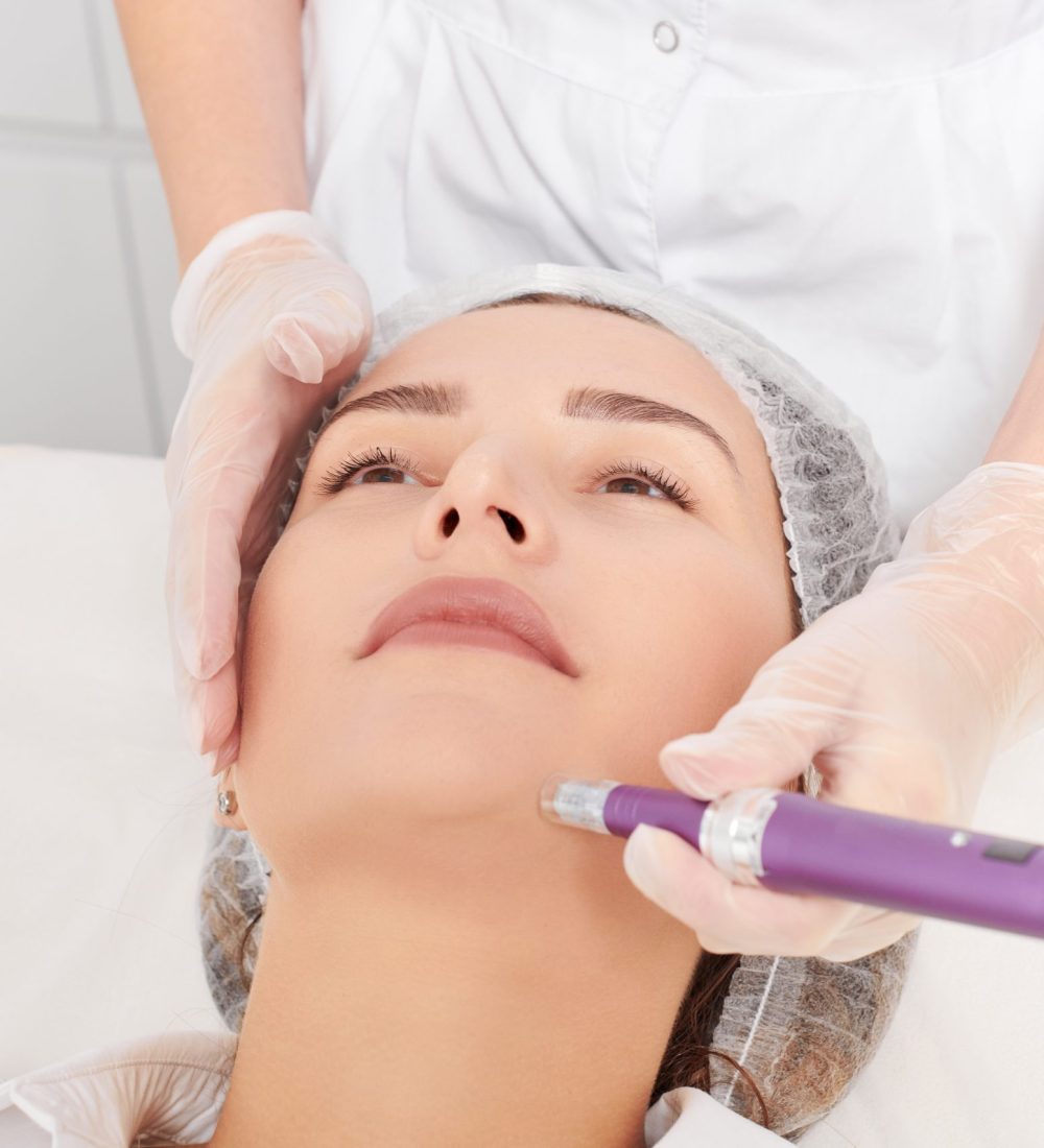 Cosmetologist makes mesotherapy injection for rejuvenation woman face, anti aging non surgical cosmetic procedure in beauty salon. Beautician hands in gloves makes facial micro needle injections